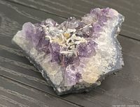Overall view of amethyst quartz crystal cluster on dark background
