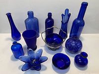 All twelve cobalt blue glass pieces grouped together