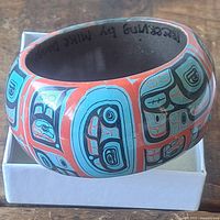 Angled view showing painted motifs and bracelet width