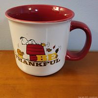 Mug front showing Snoopy graphic and text