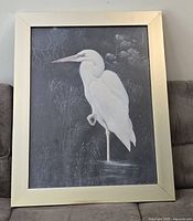 Full view of framed lithograph with heron imagery