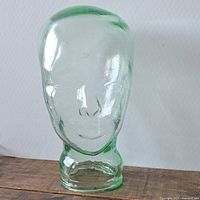 Front view of light green glass mannequin head