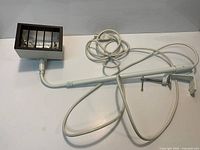 Full view of spotlight showing arm, clamp, cord and lamp head