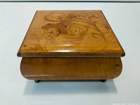 Closed music box showing floral inlay lid