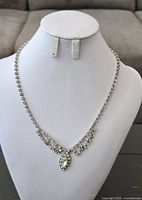 Necklace displayed on bust form showing full design and clasp