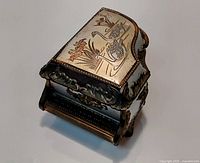 Closed box showing top swan design and ornate front