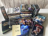 Wide view of the collection showing various DVD and Blu-ray cases stacked, with visible titles such as Skyfall, King's Speech, Avatar, Star Wars, Guardians of the Galaxy, and more.