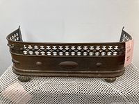 Front and side views showing brass construction with decorative cutouts and claw feet