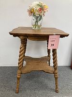 Full view of antique oak parlor table with barley twist legs and lower shelf, showing overall design and structure.