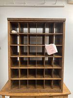 Front view of the full wooden post office pigeon hole sorting cabinet showing 6 rows and 5 columns of compartments.