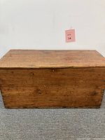 Front and top view of rustic pine wooden chest showing aged wood surface and overall construction.