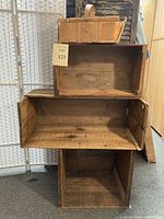 Three wooden crates stacked; largest bottom, medium middle, small top effects; natural wood tones and visible use.