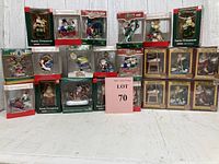 Full lot of 17 boxed Christmas ornaments showing a range of themes including Santa, vintage holiday, cartoon, and sports. Boxes display brand logos and years.
