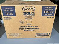 Closed cardboard box indicating contents as 1000 pieces of 12oz Solo Ultra Clear Plastic Cups, stock number TP12S, by Dart.