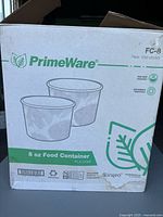 Box packaging of PrimeWare 8 oz food containers showing brand and product details including PLA lining, heat resistance, and compostability.