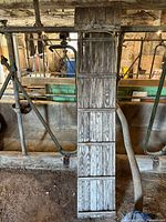 Full top-down view of the wooden toboggan showing segmented boards and metal reinforcements.