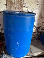 Side view of the blue barrel showing measurement markings and surface wear.