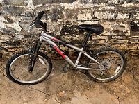 Full side view of the Mongoose Byte bike showing the entire frame, wheels, seat, and handlebar condition.