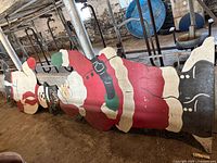 Santa and Frosty snowman wooden cutouts lying on the ground with visible paint detail and structural shape.