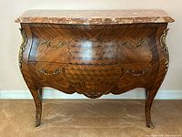 Front view of walnut commode with parquetry inlay and marble top
