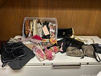 Overview of the collection showing a variety of leather, embroidered, and beaded purses, both vintage and modern, arranged on a white surface.