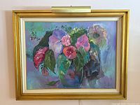 Frontal view of the large floral acrylic painting in its gold frame, showing the overall artwork and attached light.