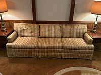 Front view of the 3-seater sofa showing its striped yellow and gold upholstery and three back cushions.
