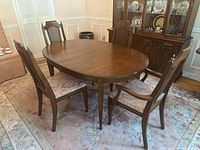 Full view of oval table with four chairs arranged around it