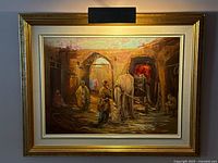 Full view of framed painting with mounted lamp