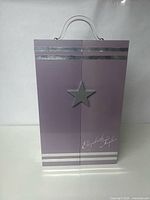 Front view of closed lavender Franklin Mint Elizabeth Taylor Vanity Closet with star detail and signature