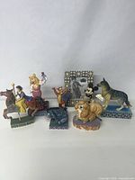 Group shot of all seven Jim Shore figurines on plain background