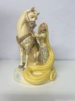 Front view of Rapunzel figurine with horse showing the long hair wrapping the base.