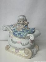 Cookie jar showing entire sleigh body with Santa and gifts on top, displaying colors and design.