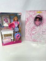 Both dolls displayed side by side, one in original box and one in window box with accessories visible.
