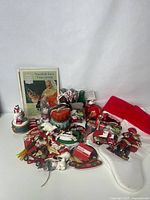 Full view of Coca-Cola vintage ornaments, Santa and polar bear figurines, musical figurine, and two red and white Christmas stockings.