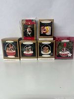 Seven boxed Hallmark Keepsake Magic and Motion and Magic Collector's Series ornaments arranged on a white background, showing box fronts with holiday-themed illustrations and characters.