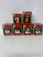 Photo showing seven boxed Hallmark Keepsake Magic Light and Motion collectible ornaments from the Forest Frolics collection arranged in two rows.
