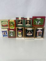 Photo of 10 vintage Hallmark Keepsake Christmas ornaments in original boxes arranged in two rows.