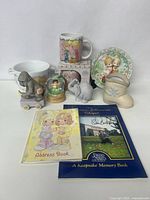 Full lot with mugs, bowl, plate, figurines, snow globe, and books