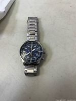 Front view of Citizen Eco-Drive watch showing blue dial with chronograph features and stainless steel band.