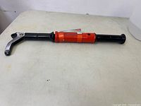 Full view of the Crescent 19 inch sliding nail puller showing the orange and black handle and curved claw end