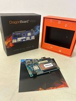 Front view of DragonBoard 410c with box and manual showing board details and packaging.