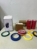 Overview of the lot items including heater box, two smaller boxes, and multiple rolls of flagging tape in assorted colors.