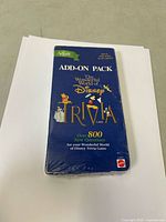 Front view of sealed blue add-on pack for The Wonderful World of Disney Trivia Game with artwork of Disney characters and text indicating over 800 new questions.