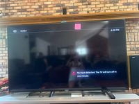 Front view of 70-inch Sony television powered on, displaying no input message