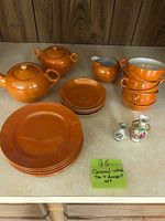 Shows entire tea and dessert set with caramel-colored glaze and two small decorative vases
