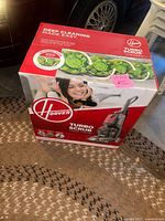 Box of Hoover Turbo Scrub carpet washer showing front and side images with branding and features.