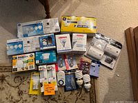 Full overview of all items including boxed lightbulbs, miscellaneous loose bulbs, and CO2 alarm package.