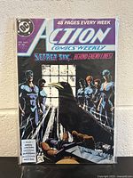 Photo of Action Comics #607 comic book, showing front cover with characters and title.