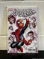 Front cover of Marvel's The Amazing Spider-Man #605 comic book with Spider-Man and surrounding characters on a white and pink background.